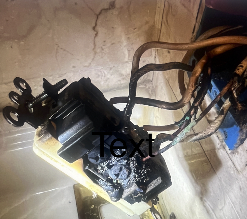 Burning Smell From Outlet Encinitas CA — burned outlet with overheated wiring inspected by a licensed electrician