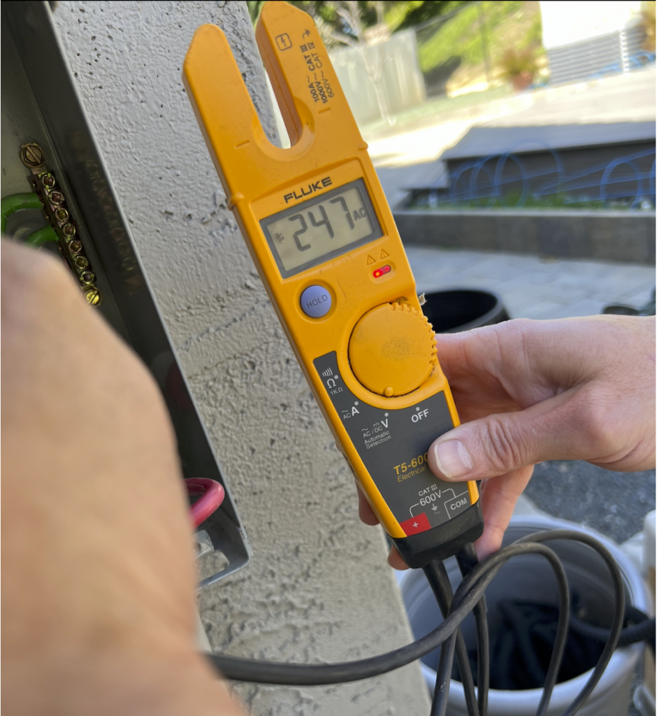 Encinitas electrician testing circuit breaker with Fluke electrical tester